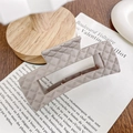 Light brown quilted hair claw clip with matte finish on a vintage book background - 10.5cm / Milk Coffee