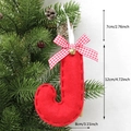 Christmas letter J ornament with red plaid bow and bell hanging on a green tree branch - J-Bell
