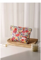 Macro detail of floral cotton toiletry bag with H&R BAG label on a wooden tray - Red Floral