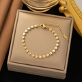 Elegant gold bracelet featuring radial sunburst discs and a K18 engraved tag - Embossed Disc Bracelet / Gold