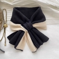 Detail of a black and white checkered knit scarf with a soft texture and knotted design - Black