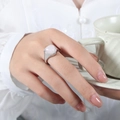 Elegant gold plated titanium ring featuring a triangular pink stone inlay on model's finger - US 6 / Silver Band / Rose Quartz