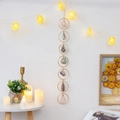 Golden Tree of Life crystal pendant with natural agate slice on a decorative wall - Danxia Seven Rings Rough Stone
