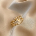Close-up of golden V-shaped double-layer ring with crystals on champagne silk background - Style B-V-Shape Double Layer Zircon