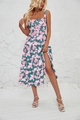 Detail view of floral midi sun dress featuring pink flowers on dark green fabric with side slit - Blue with Red White Floral