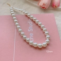 Elegant 12mm pearl necklace with golden adjustable chain on pink background - 12mm / Gold