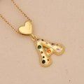 Close-up of golden heart pendant with letter A and multi-colored cubic zirconia stones - Letter A / Gold