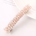 Detailed macro view of a pink crystal beaded spring hair clip with faceted glass accents - Pink