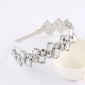 Elegant silver hairband with rectangular and round crystals resting on a white cup - Style 04-All White Rhinestone