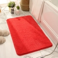 Thick red absorbent rectangular bathroom mat with plush texture on white marble floor - Cherry Red