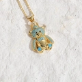Golden crown bear necklace with blue turquoise beads on a textured white background - Light Blue Zirconia