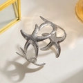 Modern silver starfish napkin ring with textured metal finish for elegant dining tables - Silver Starfish Grains