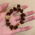 Ethnic coffee bean bead bracelet with orange spacers and white cat paw charms - Coffee Bean Cat Claw Bracelet
