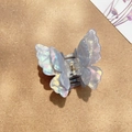 Iridescent butterfly hair claw clip with blue and purple gradient on textured background - Pointed Wing Iridescent Blue
