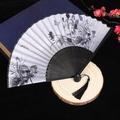 Classic Chinese folding fan with black bamboo ribs and floral peony pattern with silk tassel - Lotus