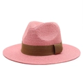 Detail of pink straw Panama hat featuring finely woven texture and a brown ribbon band - Dusky Pink