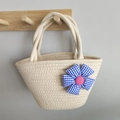 Handwoven cream cotton rope handbag with a blue checkered flower detail on a wooden hook - Blue Bow Flower / Off White