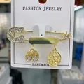Golden Hamsa hand brooch with sparkling rhinestones and a crown motif charm - White Circle
