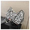 Close-up of leopard print shoulder bag with a half-moon shape and secure zipper closure - White Leopard
