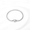 Silver snake chain bracelet with heart-shaped clasp on a white textured backdrop - Steel Color Heart Clasp