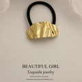 Golden irregular wavy metal hair tie with black elastic band for minimalist styling - Curved Ripple Pleated Gold