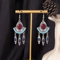 Close-up of bohemian tassel earrings with red and blue stones on a display stand - S4297-1 Red Alloy Acrylic Mixed Earrings