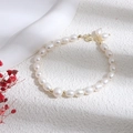 Elegant white freshwater pearl bracelet with a gold clasp on a minimalist white surface - White Rice Pearl Bracelet