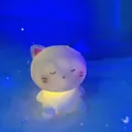 Cute cat night light with blue hat and warm yellow glow in a dreamy blue setting - Sleepy Cat