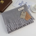 Elegant light gray cashmere-feel scarf with long fringe and branded tags in a lifestyle set - Medium Grey / 200cm