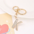 Detailed view of rhinestone-studded gold letter K keychain with lobster clasp and ring - Letter K