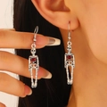 Gothic silver skull drop earrings with red heart detail on minimalist white background - Red Heart Jointed Skeleton (DZ-874) / Antique Silver