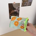 Close-up of mint canvas cosmetic pouch with orange floral print and neon green zipper cord - Calla Lily Orange Floral