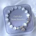 Detail of light blue cat eye bead bracelet with silver hollow charm in a jewelry box - Grey-Cat Eye