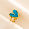 Close-up of gold stainless steel ring featuring a heart turquoise stone on silk background - Gold Tone-Blue Turquoise Look (J549-G-DB)