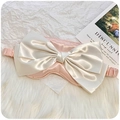 Elegant pink satin sleep mask featuring a large creamy white bow and elastic strap - Girl Pink