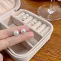 Various sizes of white round pearl stud earrings in a beige jewelry storage case - 8mm (No Packaging)