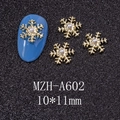 Macro detail of 10x11mm gold snowflake nail charms with faux pearls on blue manicure - Gold Large Pearl Snowflake Style (A602)