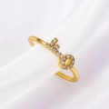 Golden key charm ring with sparkling zircon pavé setting on a white silk background - Gold Zirconia Key Pendant Ring (G-216)