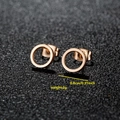 Minimalist rose gold stainless steel round stud earrings on a black display stand - 011 Rose Gold Ring