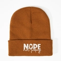 Knitted beanie in ginger yellow featuring white NOPE not today embroidery on the folded cuff - Caramel color