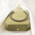 Detail of industrial steel coil bracelet on a luxury green jewelry box with silk - Densely Wrapped Conical Style (Silver#2)
