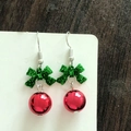 Detail of Christmas earrings featuring green glitter bows and red metallic ball pendants - Red Ball with Green Bow