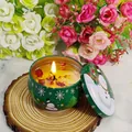 Scented soy candle in green snowman tin with dried flower petals on wood base - D222 Lavender