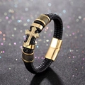 Macro detail of black braided leather bracelet with golden cross and magnetic clasp - Gold