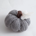 Close-up of grey knitted pumpkin with burlap stem and white leaf for harvest decor - Gray