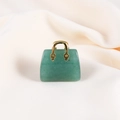 Mini green jade handbag charm with gold metal handle on beige fabric - Green Aventurine