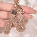 Detail view of rose gold rhinestone mushroom keychain with sparkling crystal wrist strap - Champagne