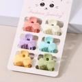 Set of six macaron-colored bow-shaped hair clips displayed on a cute feline card - Pleated Bow Style / 6-Piece Set