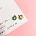 Close-up of donut-shaped metal jewelry pendants with blue enamel and gold finish - 5# Blueberry Doughnut Gold