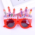 Detail of red cake-shaped birthday party glasses with colorful candles and Happy Birthday text - Cake Candle Red